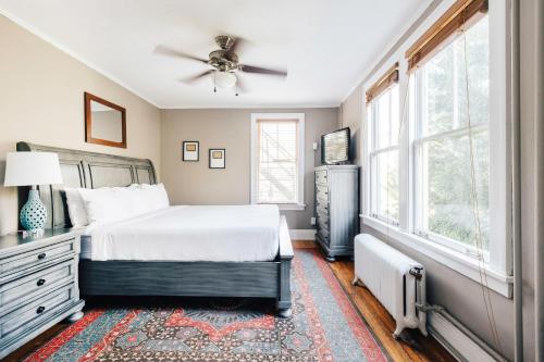 a bedroom with a bed and a ceiling fan at Princess Anne Boutique Hotel & Breakfast in Asheville