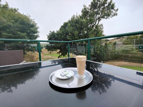a cup of coffee on a table on a balcony at Best Western The Dartmouth Hotel, Golf & Spa in Dartmouth