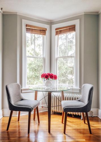 a dining room with a glass table and two chairs at Princess Anne Boutique Hotel in Asheville