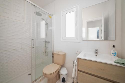 a bathroom with a shower and a toilet and a sink at Casa Julia in Playa de las Americas