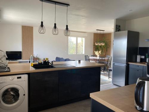 a kitchen with a sink and a dishwasher at Gîte "le haut des Poujades" in Reilhaguet