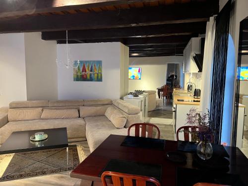 a living room with a couch and a table at Tiltų 5 Apartment in Klaipėda