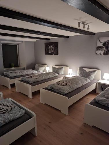 a large room with four beds and a tv at Flensburg Zentrum 69 05 in Flensburg