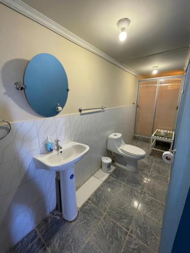 W łazience znajduje się umywalka, toaleta i lustro. w obiekcie Cabañas Pankara w mieście San Pedro de Atacama