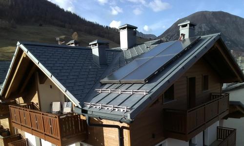 a house with a solar array on the roof at Appartamento Suite centro Livigno 4S - Sabrina in Livigno
