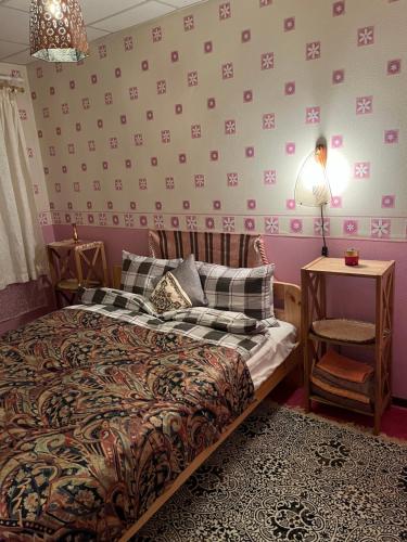 a bedroom with a bed and a table and a lamp at Cosy Appartment. Püssi town in Pyussi