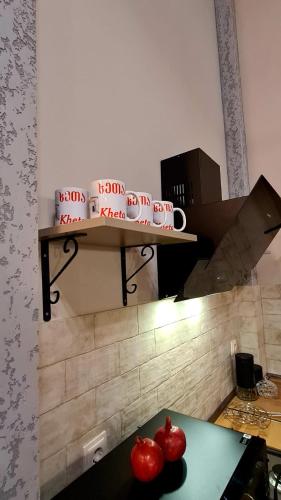 a table with two tomatoes on a shelf in a room at Kheta Apartments Kazbegi in Stepantsminda
