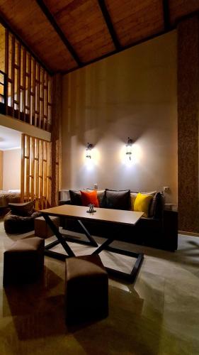 a living room with a couch and a table at Kheta Apartments Kazbegi in Stepantsminda