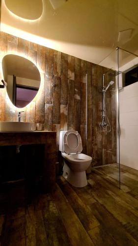 a bathroom with a toilet and a sink and a mirror at Kheta Apartments Kazbegi in Stepantsminda