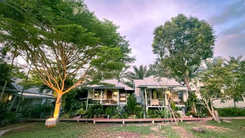 a house with trees in front of it at Rimsira in Chumphon