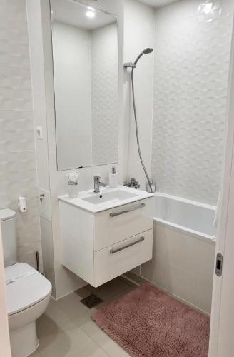 a bathroom with a sink and a tub and a toilet at Hils Pallady Apartament Lyly in Bucharest
