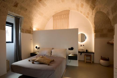 a bedroom with a large bed with an arched ceiling at Musae Relais & SPA in Polignano a Mare