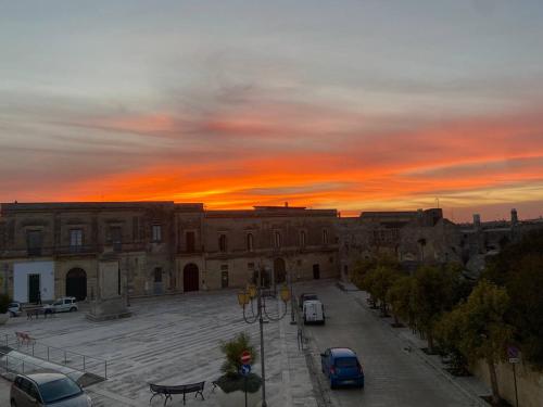 a view of a building with a sunset in the background at Palazzo Vecchio Cocumola in Cocumola