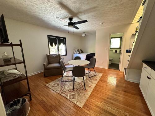 a living room with a table and chairs at Sylvan Valley Lodge and Cellars in Sautee Nacoochee