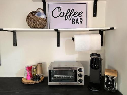 a kitchen counter with a microwave and a coffee bar sign at Sylvan Valley Lodge and Cellars in Sautee Nacoochee