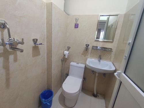 a bathroom with a toilet and a sink at Hotel Kajiinn in Pokhara