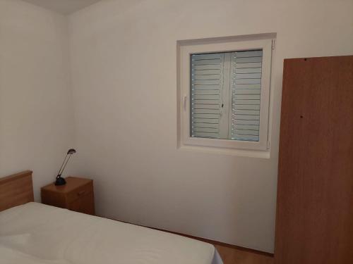 Postel nebo postele na pokoji v ubytování Apartmani Vesna