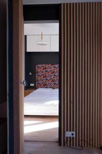 a bedroom with a bed through a doorway at Modern appartment in the heart of Cap d'Antibes in Antibes