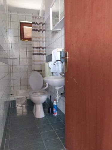 a bathroom with a toilet and a sink at Apartmani Vesna in Miškovići