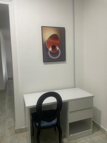a desk with a chair and a picture on the wall at Romel Terraces in Lagos
