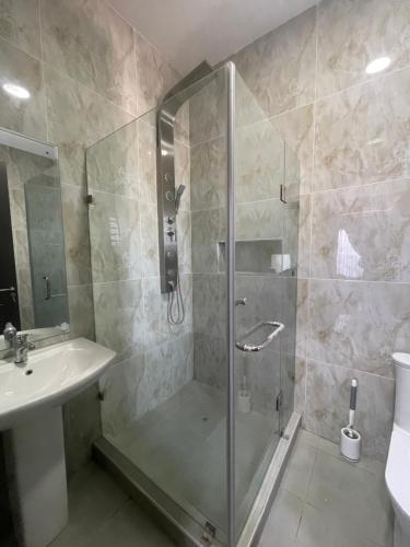 a bathroom with a shower and a sink at Romel Terraces in Lagos