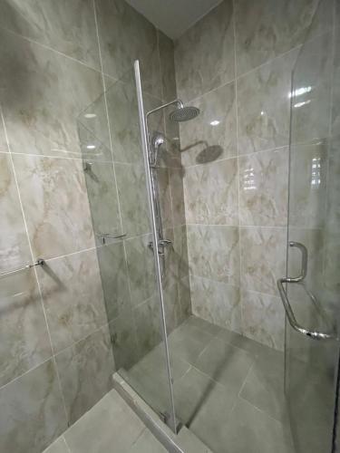 a shower with a glass door in a bathroom at Romel Terraces in Lagos