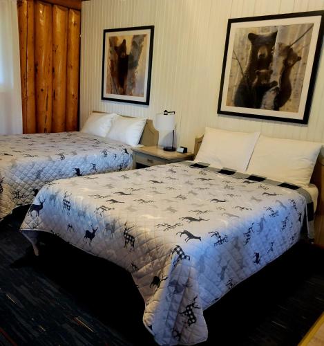a hotel room with two beds with bats on them at High Falls Motel & Cabins in Wawa