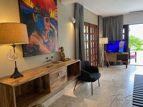 a living room with a large painting on the wall at CABARETE BEACH HOUSES the NANNY ESTATES in Cabarete