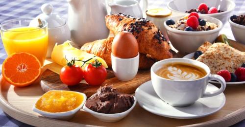a breakfast tray with breakfast foods and drinks on a table at Hotel Poniatowski in Radom