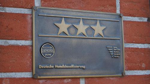 a plaque on the side of a brick wall at Hotel Flora in Herzlake