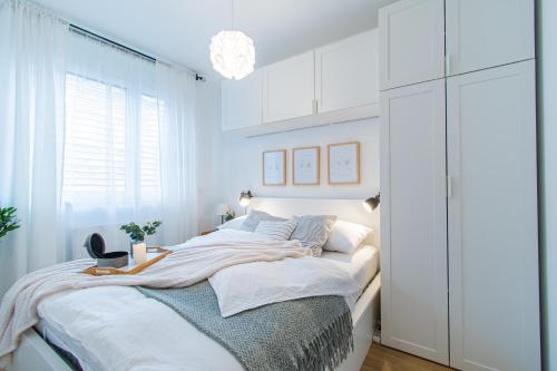 a bedroom with a bed with white cabinets at Flexible SelfCheckIns 36 - Zagreb - Garage - Loggia - New - Luxury in Zagreb