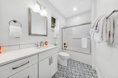 a white bathroom with a toilet and a shower at Seaside Ocean Getaway in Seaside