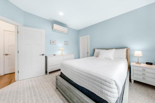 a bedroom with a white bed and two night stands at Seaside Ocean Getaway in Seaside