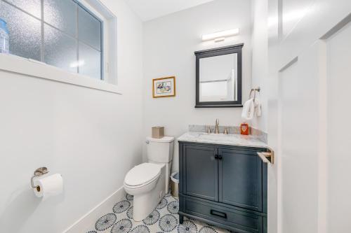 a bathroom with a toilet and a sink and a mirror at Seaside Ocean Getaway in Seaside