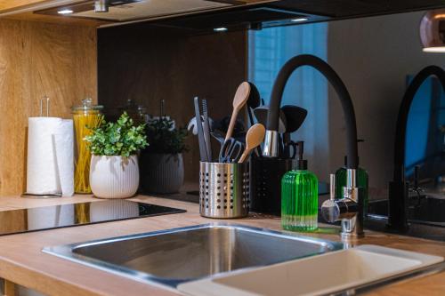 a kitchen counter with a sink and utensils at Flexible SelfCheckIns 36 - Zagreb - Garage - Loggia - New - Luxury in Zagreb