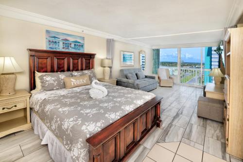 a bedroom with a bed and a couch and a chair at Daytona Beach Resort Condos in Daytona Beach