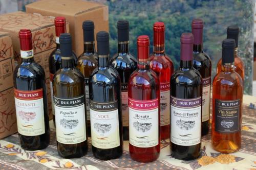 a group of bottles of wine sitting next to boxes at Due Piani in Barberino di Val dʼElsa