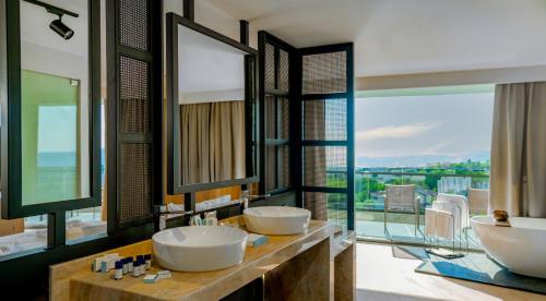 a bathroom with two sinks and a large window at Alarcha Hotels & Resort - Ultra All Inc in Manavgat