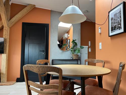 a dining room with a table and chairs and a mirror at Chopin view - Apartament z widokiem in Toruń