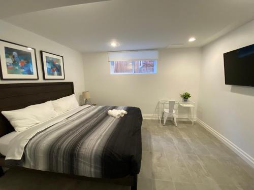 a bedroom with a bed and a flat screen tv at Yorkmills and Bayview !A Spacious and Modern Private Bdr with Shared Bathroom in Toronto