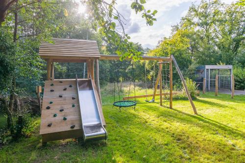 a playground with a slide and a swing at Het Dorpshuys - vakantiewoning tot 12 personen in Maaseik