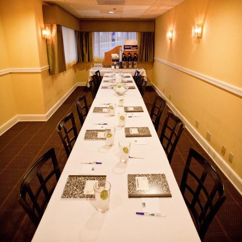a long dining room with long tables and chairs at Holiday Inn Express Grover Beach-Pismo Beach Area by IHG in Grover Beach