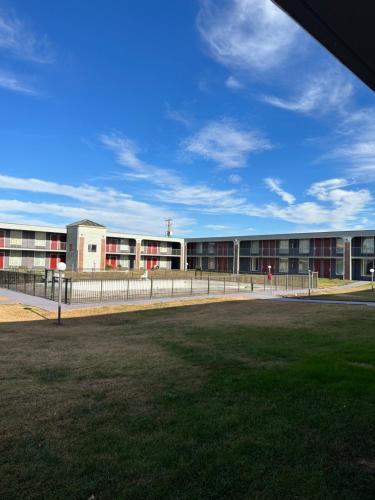 ein Schulgebäude mit roten Fenstern und einem Grasfeld in der Unterkunft USA Inn in Alcoa