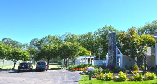 a parking lot with cars parked in front of a house at The Lodge at Jackson Village in Jackson