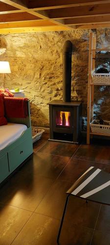 a living room with a wood stove in a room at Casa da Portela in Caminha