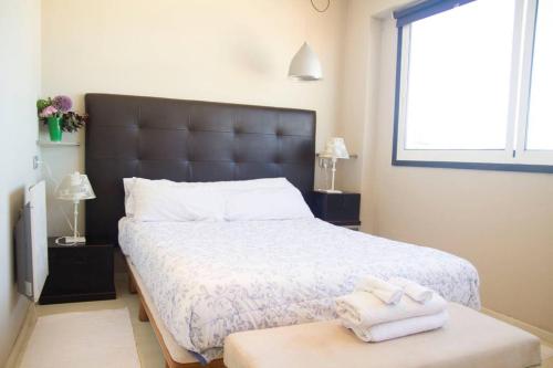 a bedroom with a bed with two towels on a table at Plaza de España View with Terrace in A Coruña