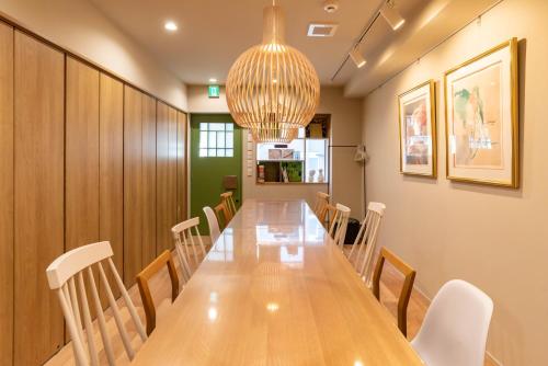 a conference room with a long table and chairs at vacation rental SARAKU 茶楽来 in Osaka