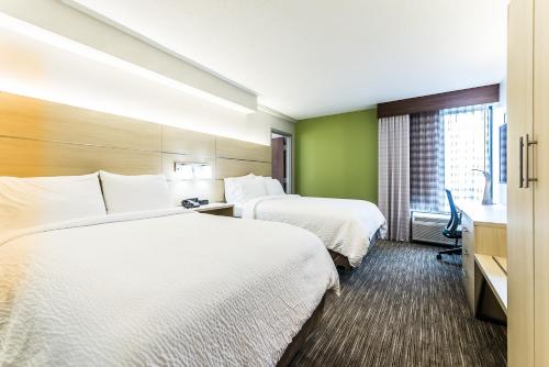 a hotel room with two beds and a window at Holiday Inn Express Flint-Campus Area by IHG in Flint