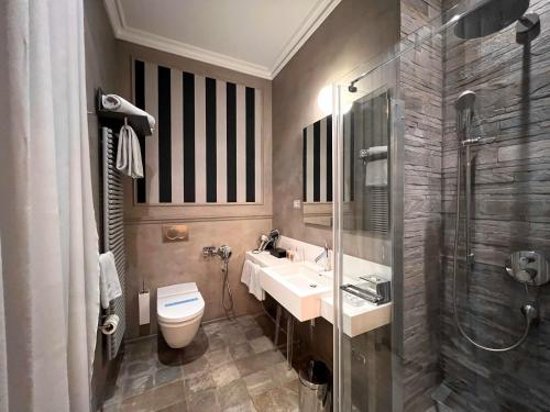 a bathroom with a toilet and a sink and a shower at Relais Metelli in Foligno