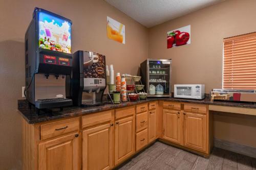 a kitchen with a counter with a tv on it at Quality Inn Redgranite in Redgranite